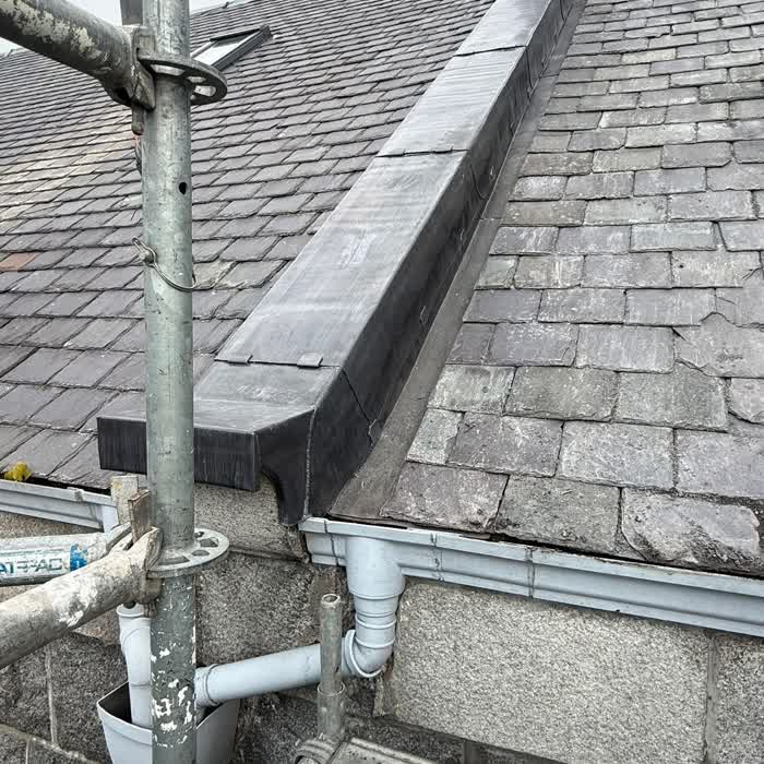 New lead hip and ridge run on a slate roof with scaffolding still in place